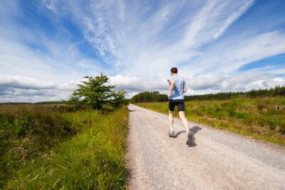 A man running while practicing proper breathing techniques for enhanced stamina and endurance.