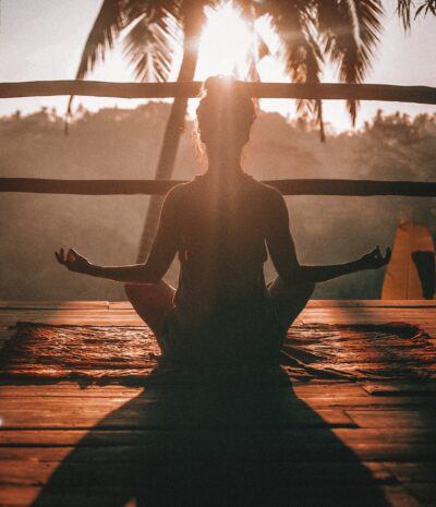 Woman practicing Kapalbhati Pranayama on a deck