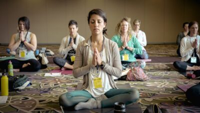 Women sitting in a yoga pose during a beginner's yoga class.